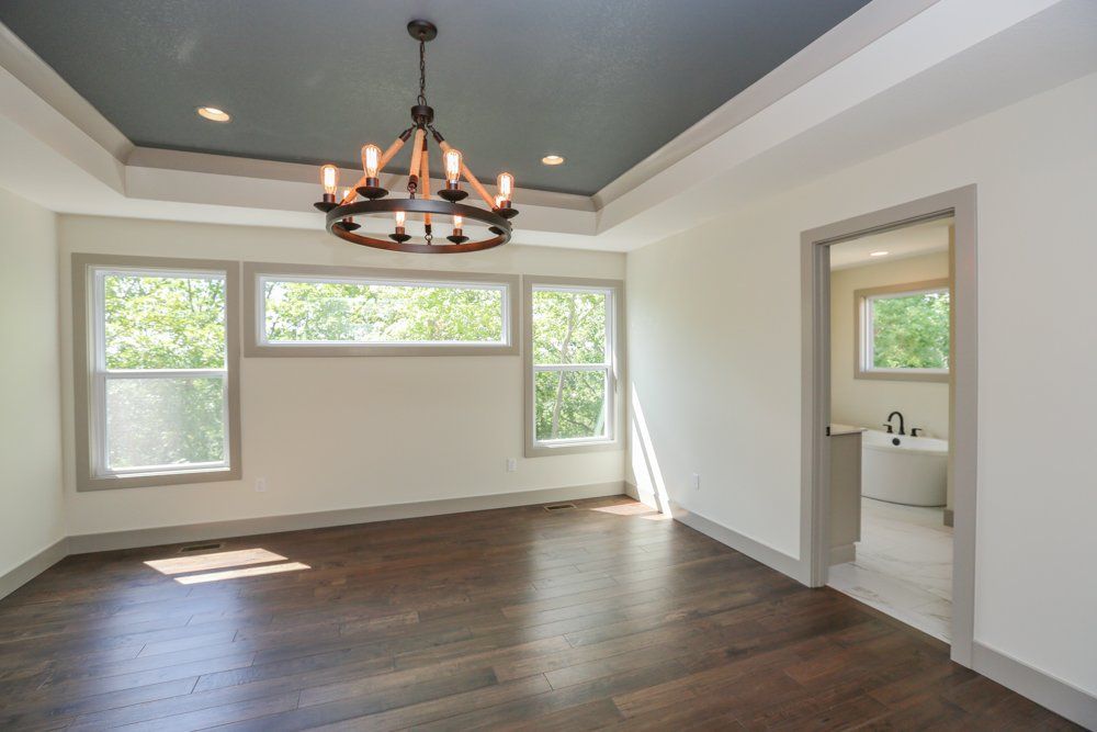 Hansman Custom Homes Designed This Spacious Room With a Chandelier in Mid-MO