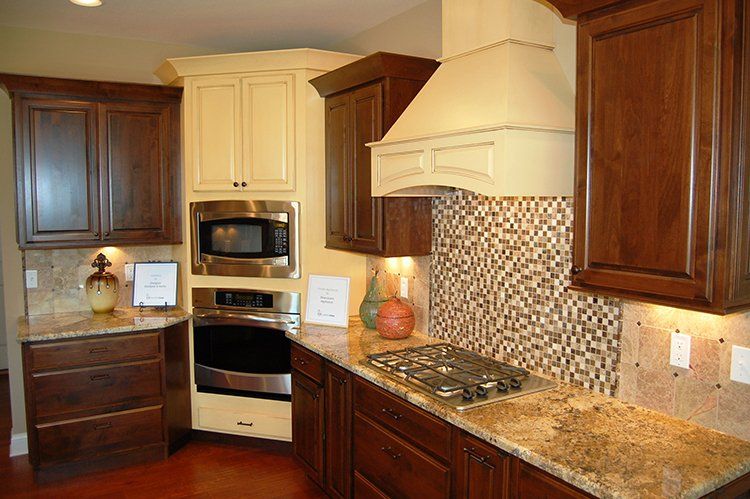 White & Brown Cabinets With Backsplash by Hansman Custom Homes in Mid-Missouri