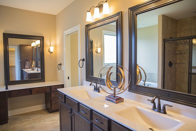 Modern Double-Mirror Bathroom With Dark Brown Lining by Hansman Custom Homes