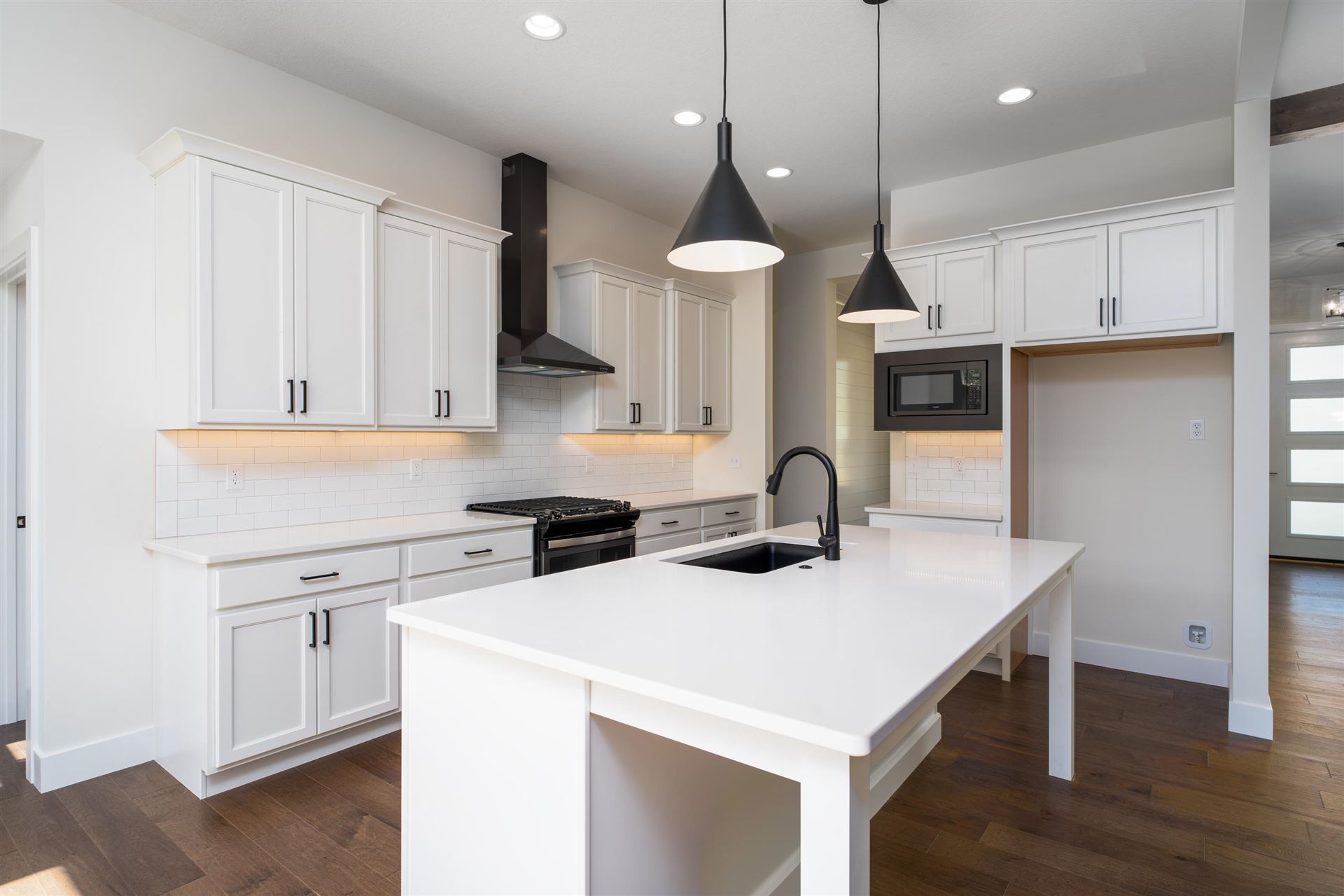 A Minimalist Kitchen With White Cabinets in Mid-MO From Hansman Custom Homes