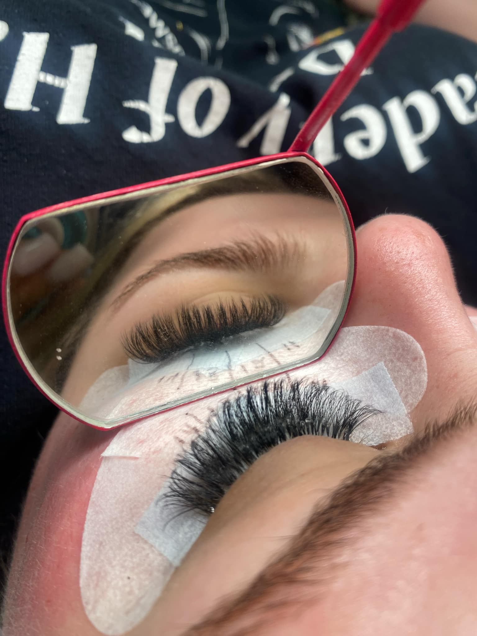 A close up of a woman 's eye with a mirror on it