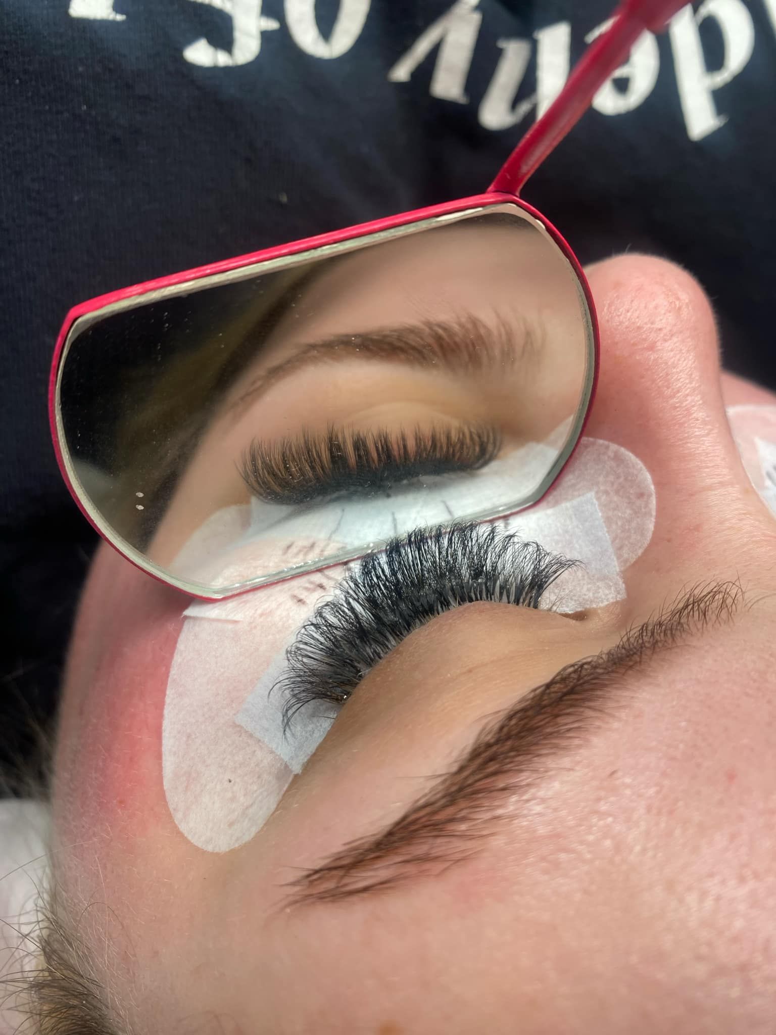 A close up of a woman 's eye with a mirror on it