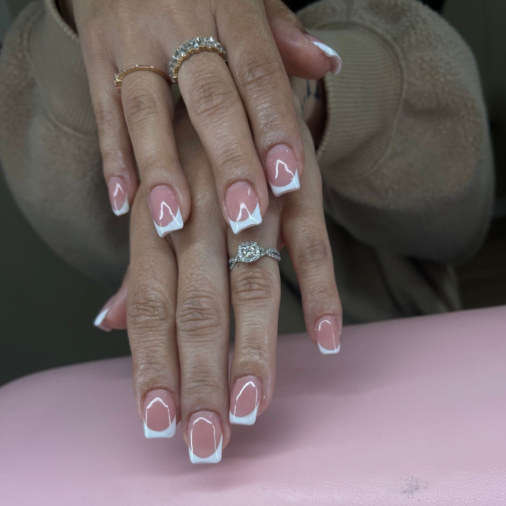 A close up of a woman 's nails with rings on them