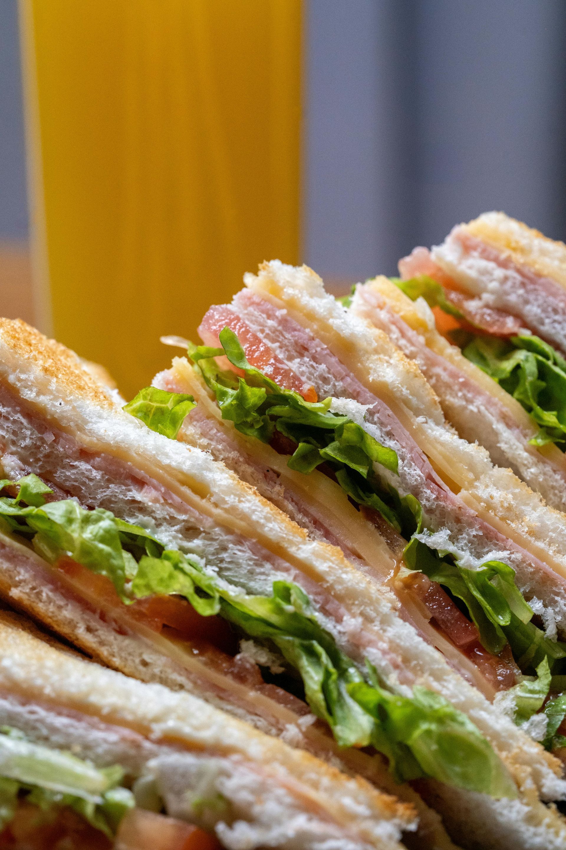 Club sandwich slices with lettuce and tomato. 