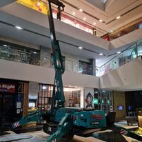 A crane is sitting in the middle of a large building.