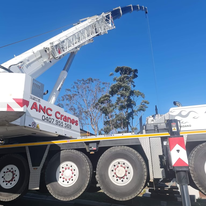 A large crane is sitting on top of a truck.
