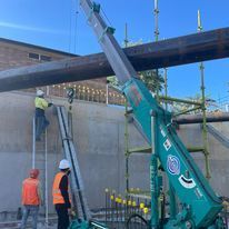 A group of construction workers are working on a building.