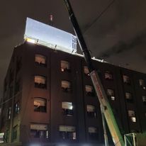 Crane installing billboard