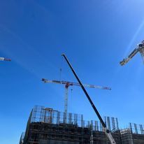 A construction site with cranes and scaffolding project in Sydney.