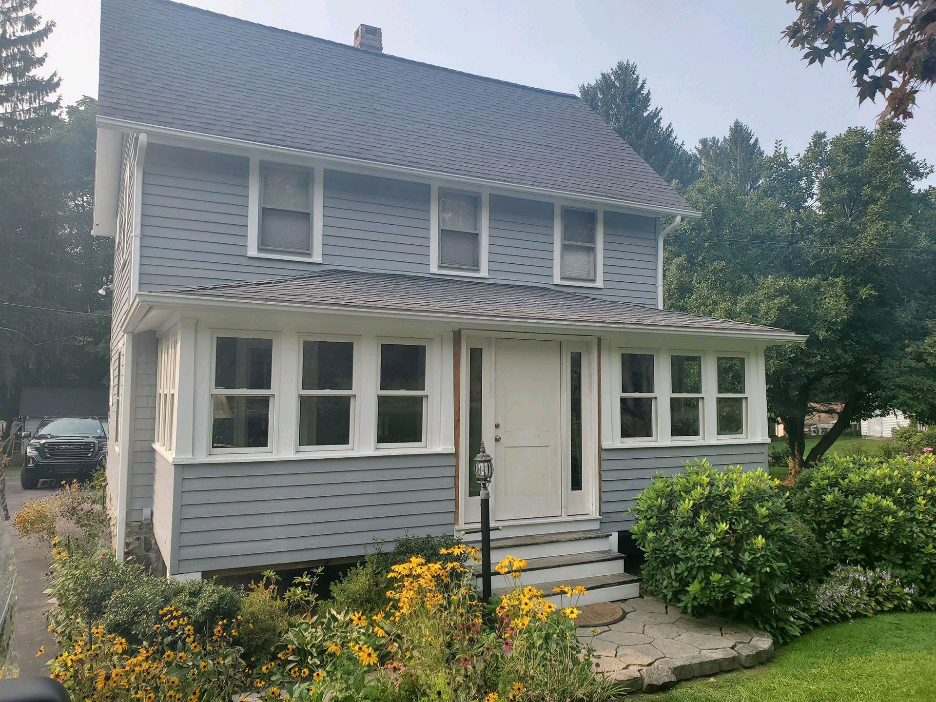 A house with a gray roof and white trim