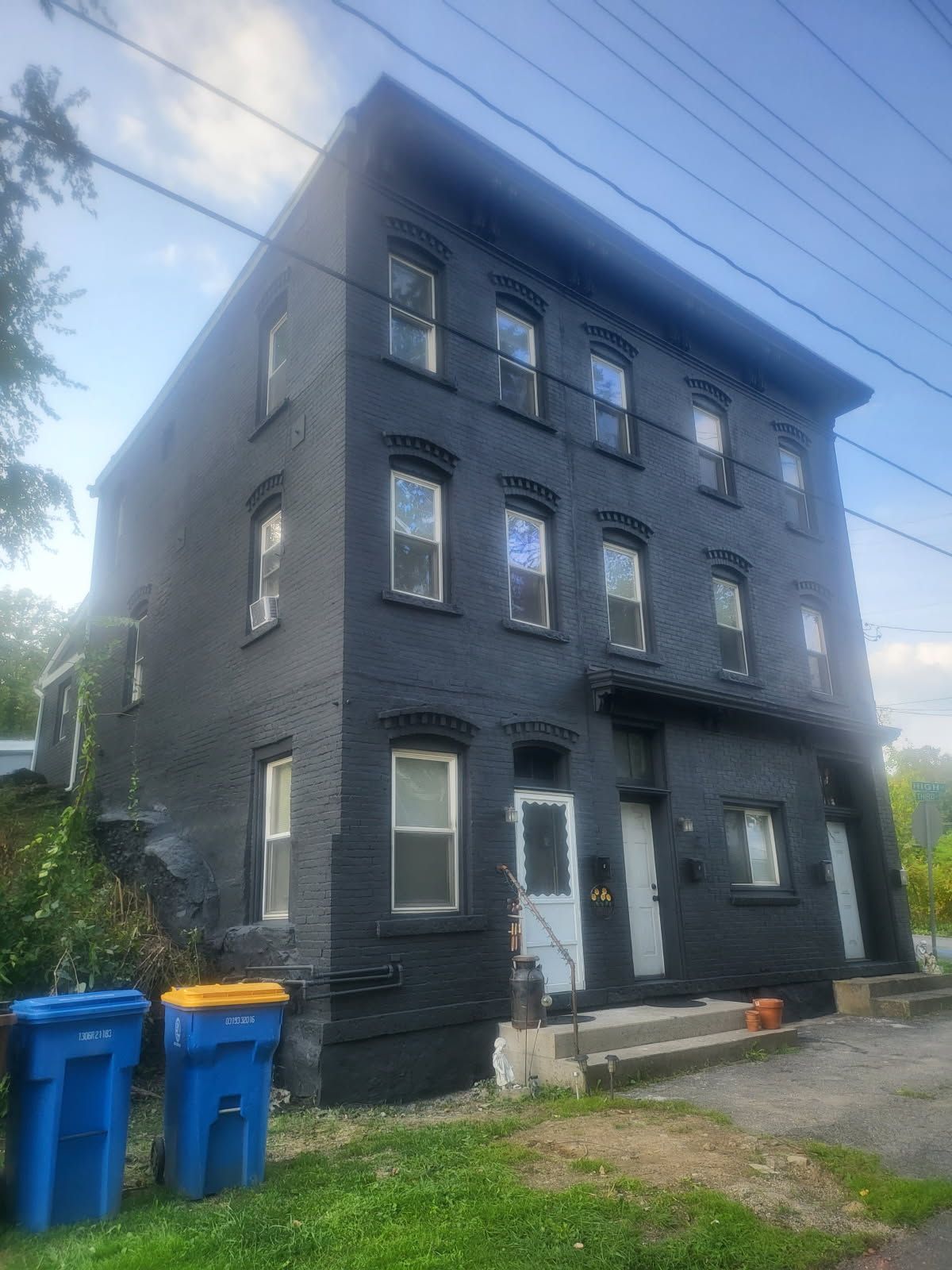 A large house with a gray roof and white trim