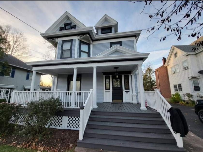 A red barn with a white silo in the background