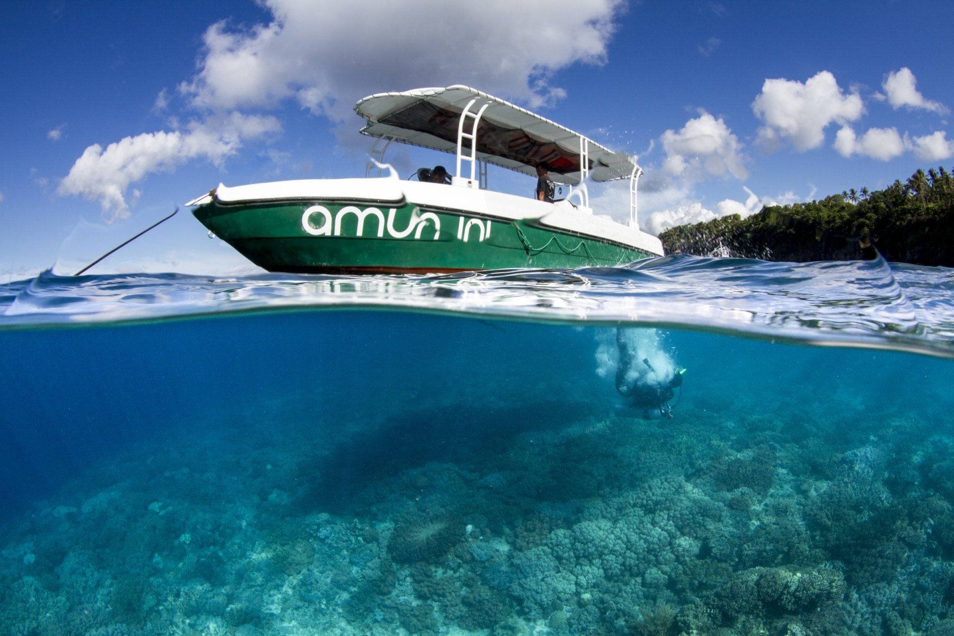 Amun Ini dive boat on clear blue water in Anda, Bohol Philippines