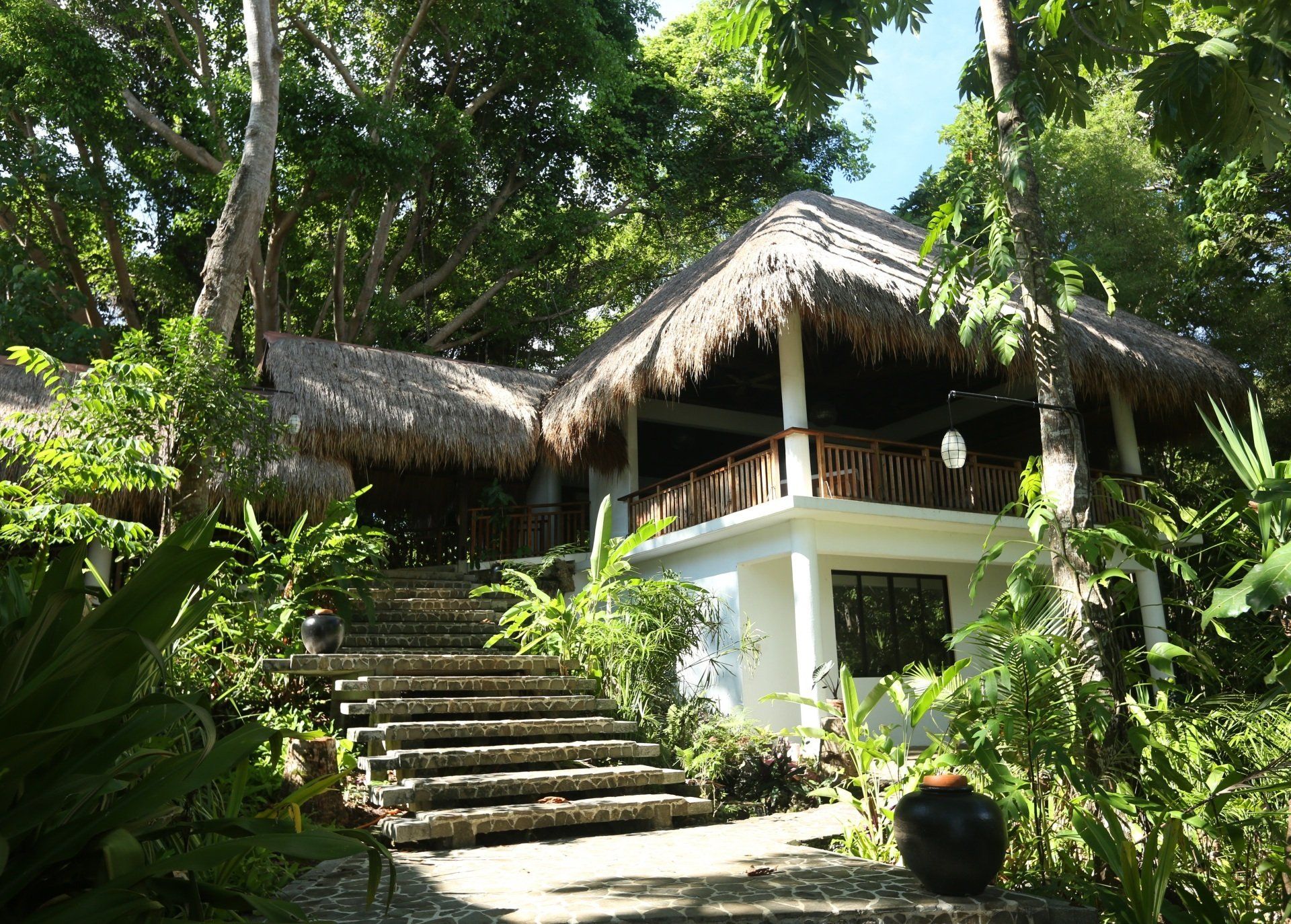 Amun Ini resort pathway leading from the reception through natural tropical landscaping.
