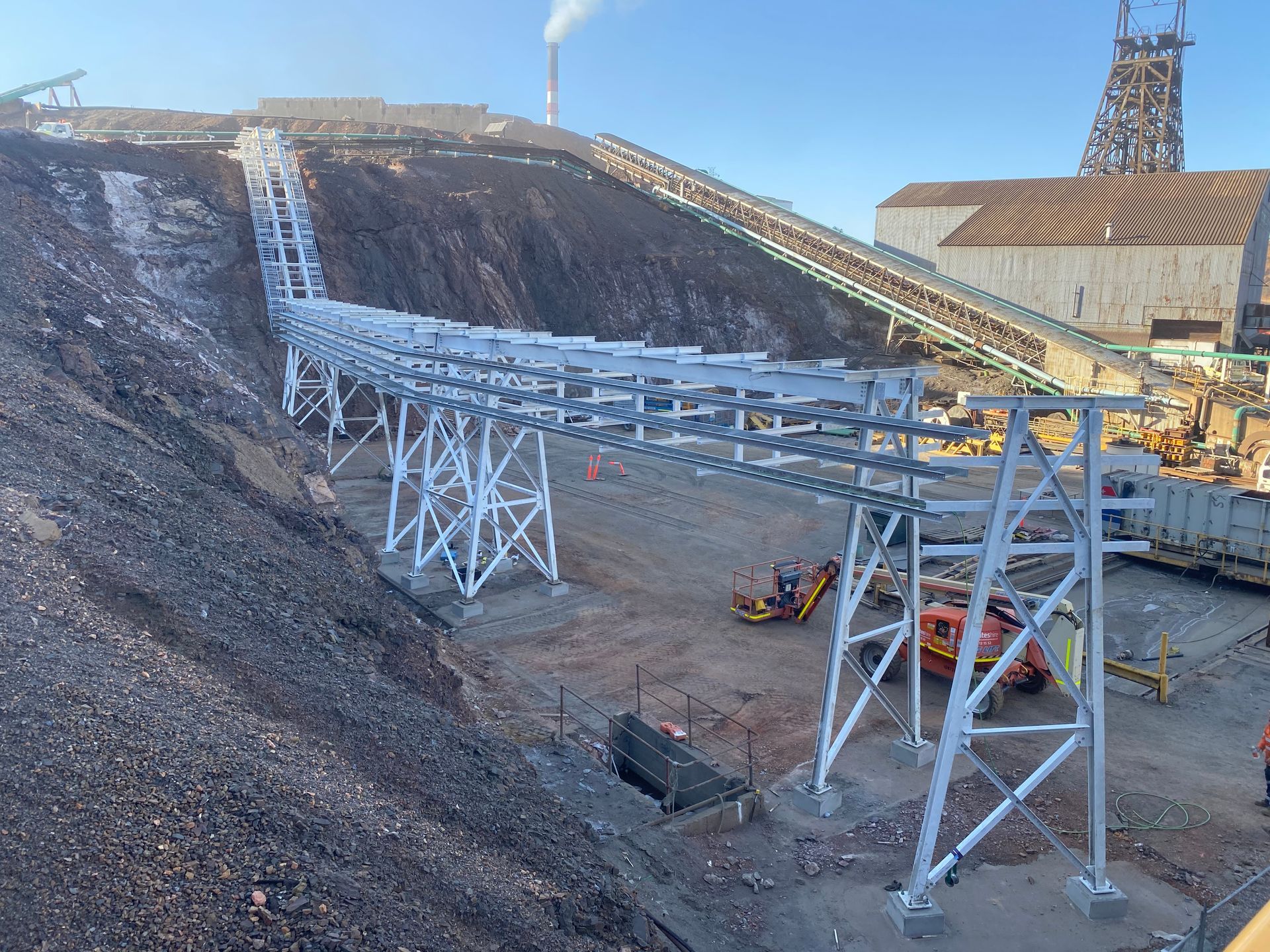 Mining Conveyor Structure on a Barren Hillside With Heavy Equipment — Vent Doors Australia in Bohle, QLD