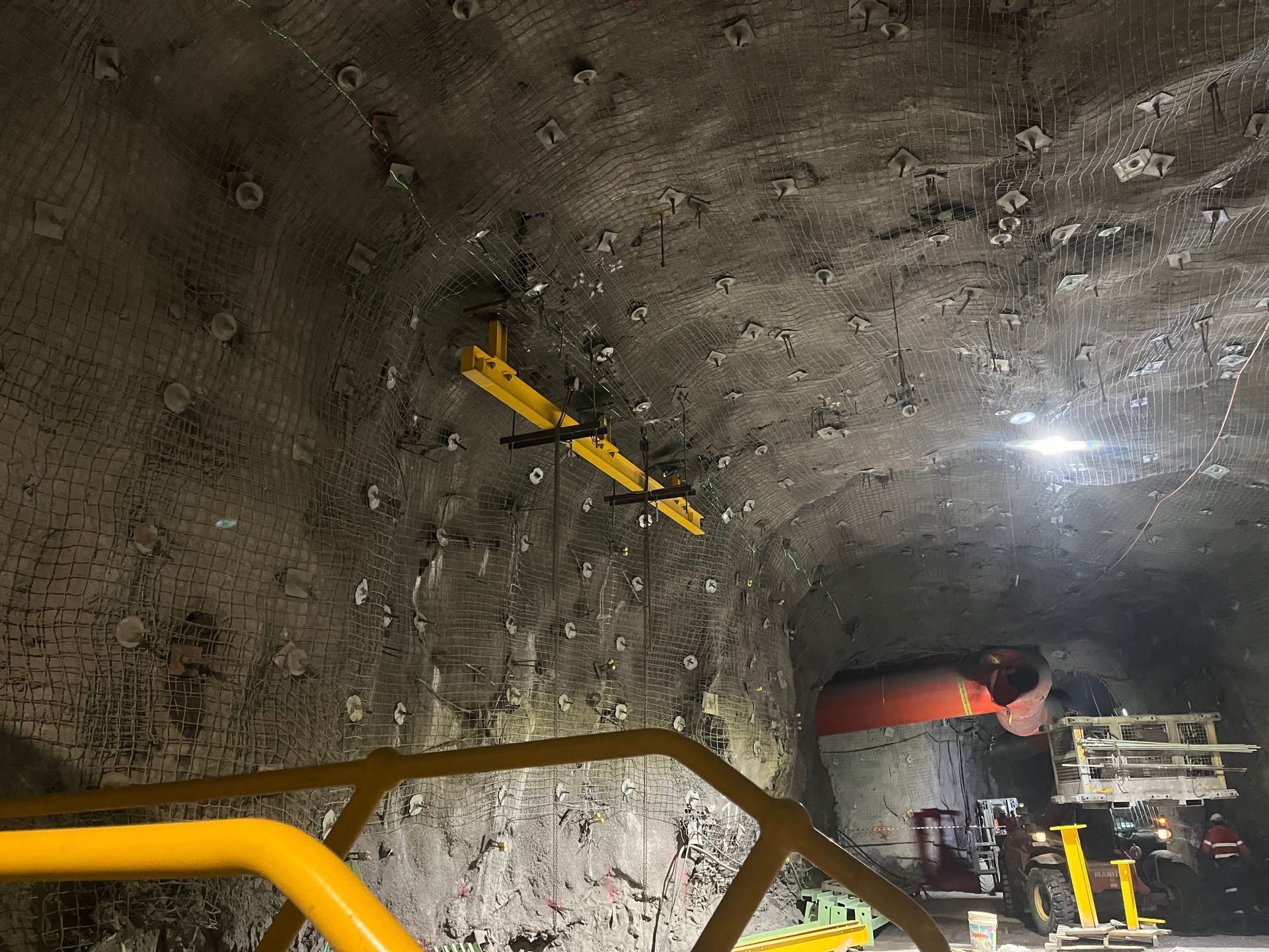 Yellow-railed Tunnel Interior With Rough Rock Walls, Pipes, and Bright Lights — Vent Doors Australia in Bohle, QLD