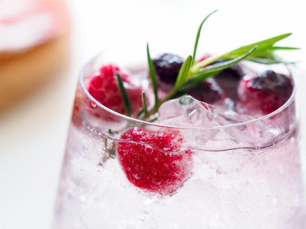 A Close up Of a Glass of Water with Raspberries and Blueberries in It — Pacific Palms Bowling Club In Smiths Lake, NSW