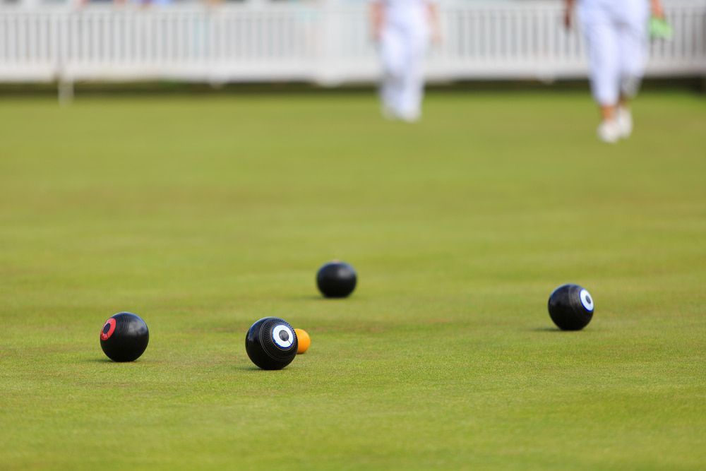A Group of Bowling Balls Sitting on Top of A Lush Green Field — Pacific Palms Bowling Club In Smiths Lake, NSW