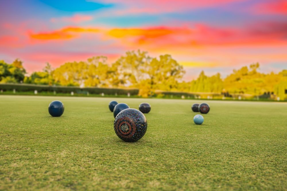 A Group of Bowling Balls Sitting on Top of A Lush Green Field — Pacific Palms Bowling Club In Smiths Lake, NSW