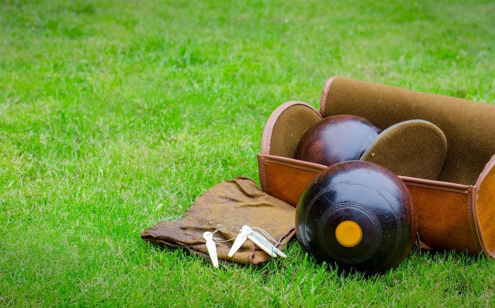 A Box of Bowling Balls Is Sitting on Top of A Lush Green Field — Pacific Palms Bowling Club In Smiths Lake, NSW