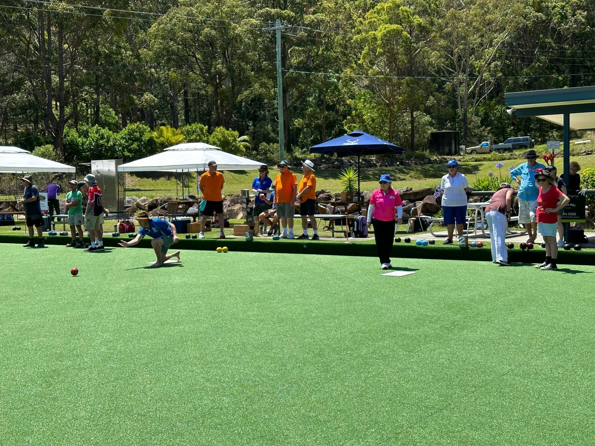 A Group Of People Are Playing A Game Of Bowling On A Lush Green Field — Pacific Palms Bowling Club In Smiths Lake, NSW