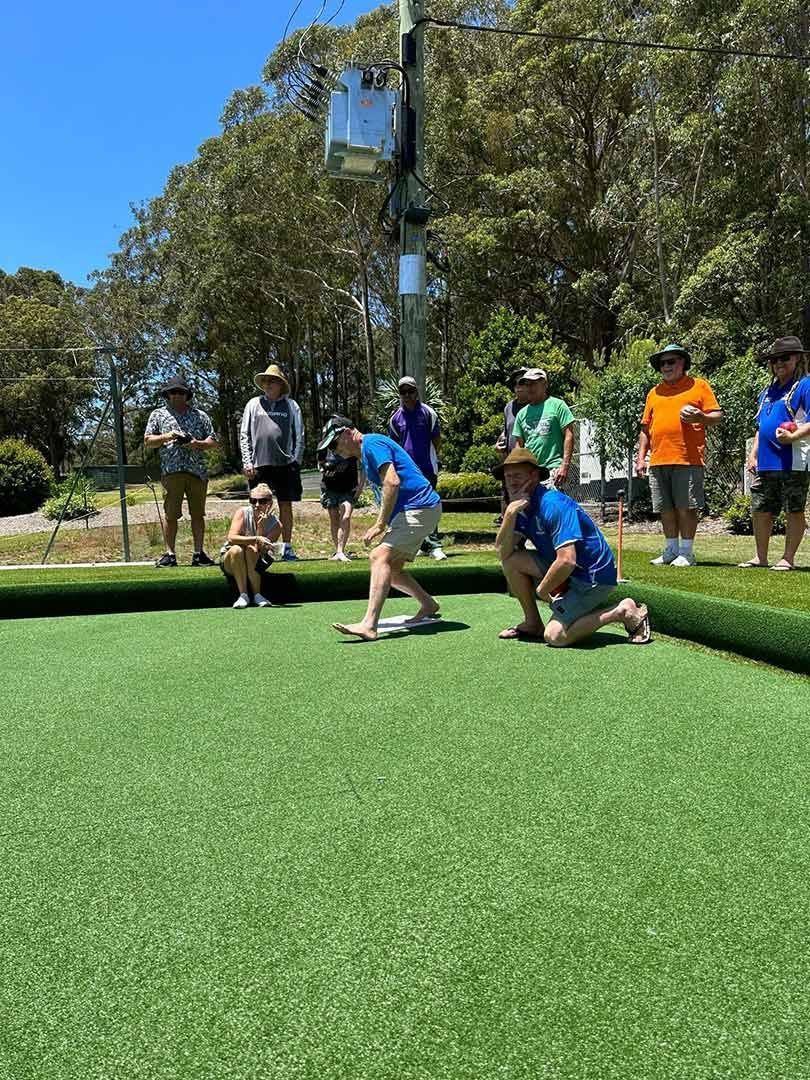 A Group Of People Are Playing A Game Of Bowling On A Lush Green Field — Pacific Palms Bowling Club In Smiths Lake, NSW