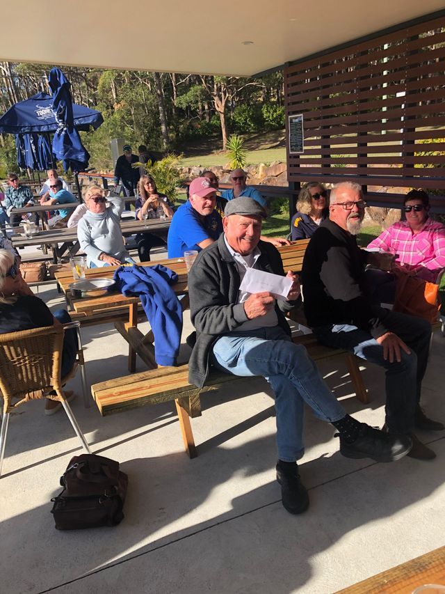 A Group Of People Are Sitting At Picnic Tables In A Park — Pacific Palms Bowling Club In Smiths Lake, NSW