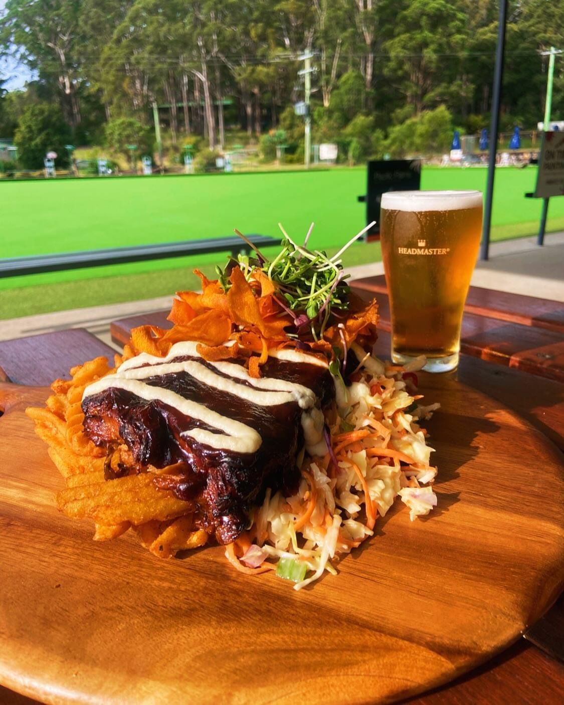 Two Steaks Are Cooking On A Grill With Flames — Pacific Palms Bowling Club In Smiths Lake, NSW