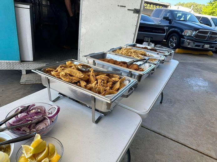 A buffet table with a variety of food on it.