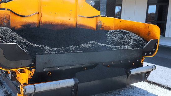 Hot asphalt being distributed inside a paving machine hopper before placement during an asphalt paving service in Highlands Ranch, CO