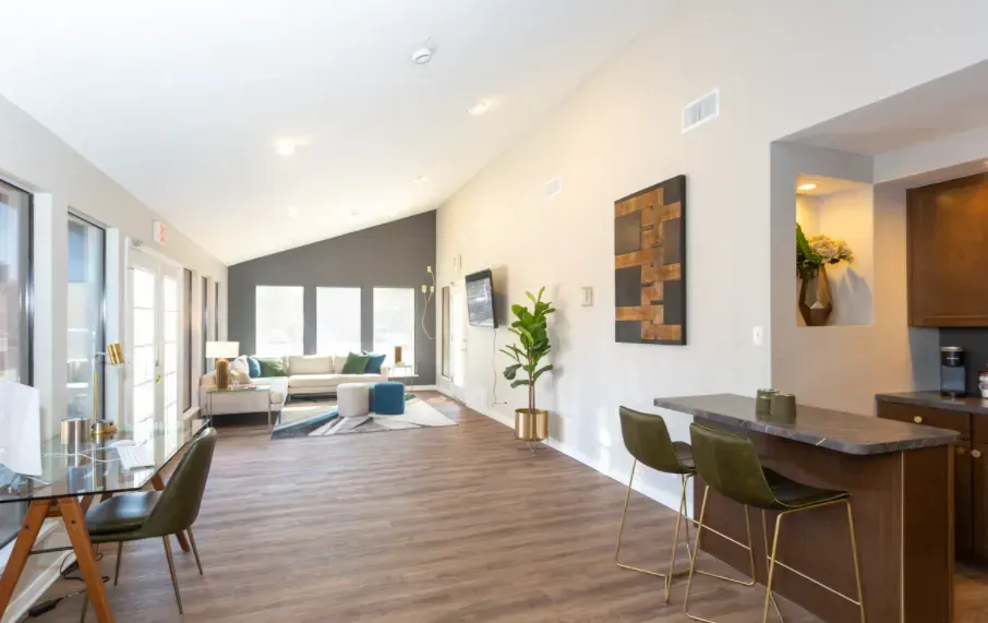 Bedroom with a bed, nightstand, lamp, decorative pillows, and round mirror.