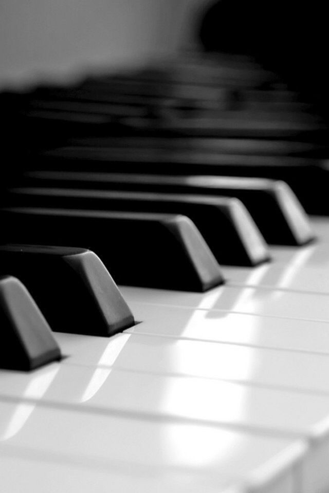 A black and white photo of a piano keyboard.