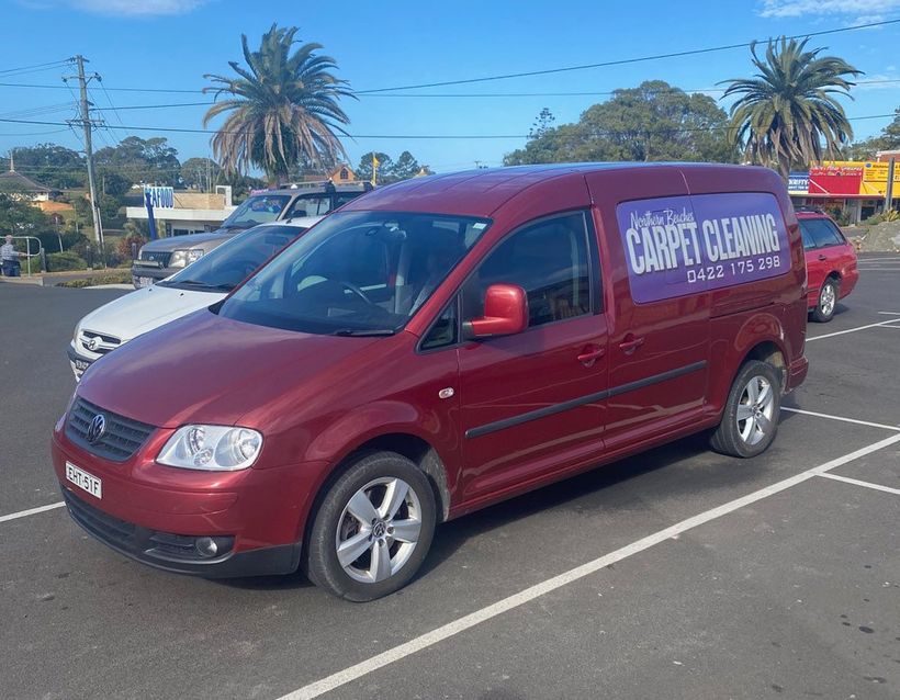 Red Car With Business Signage — Carpet Cleaning in Coffs Harbour