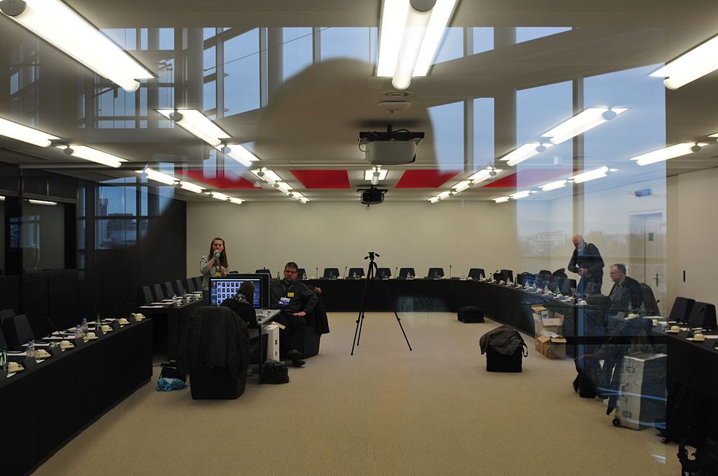 A conference room with a projector on the ceiling