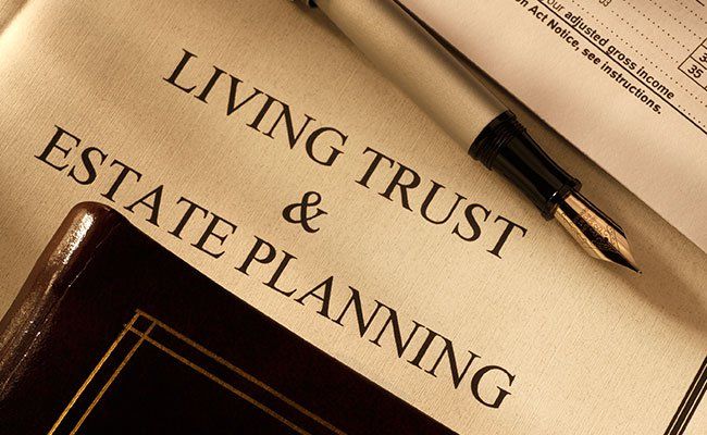 pen on paper that says living trust and estate planning
