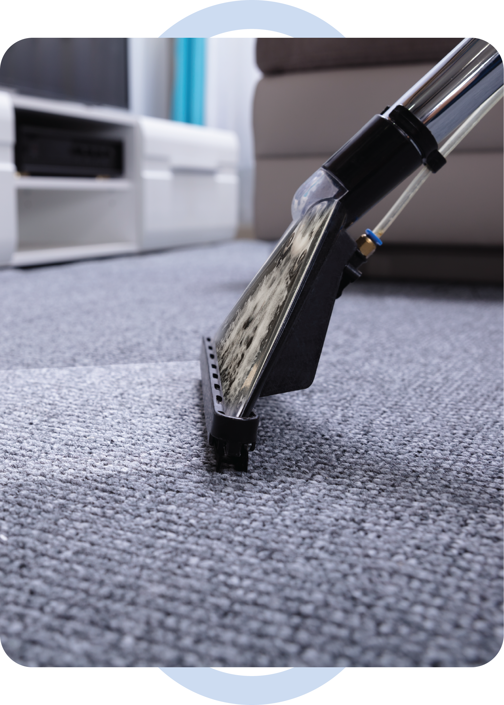 A vacuum cleaner is cleaning a carpet in a living room.