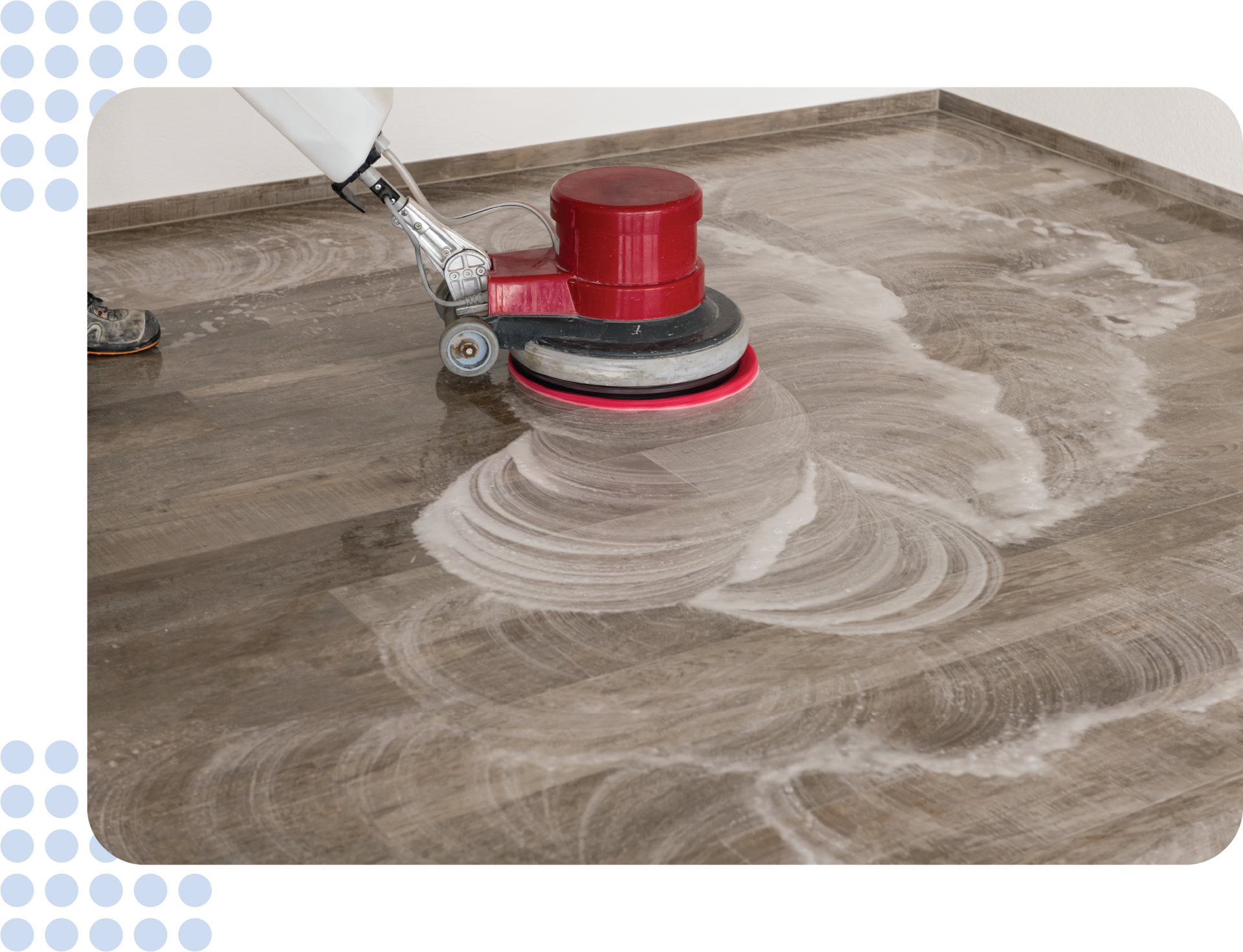 A person is cleaning a wooden floor with a machine.