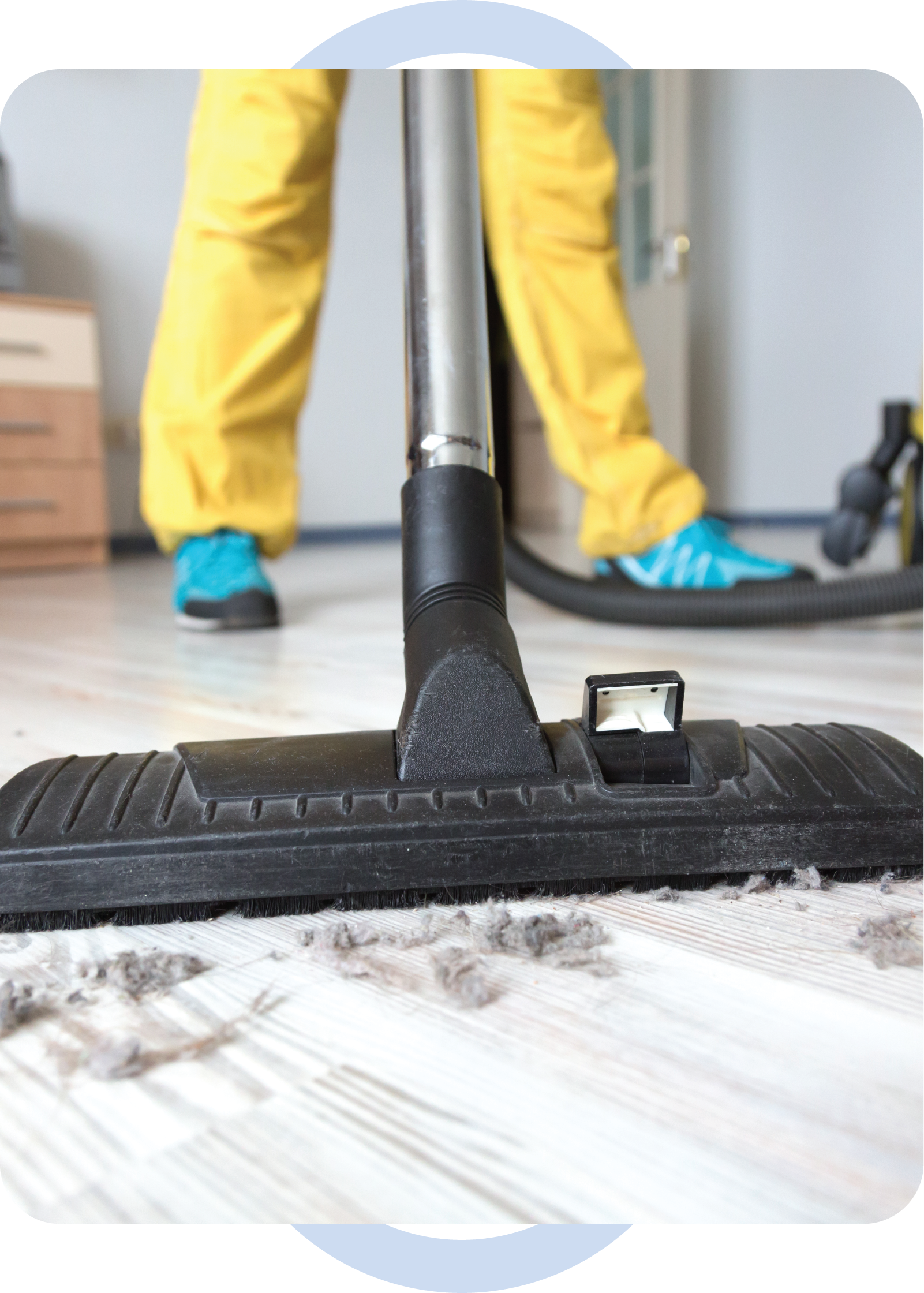 A person is using a vacuum cleaner to clean the floor.