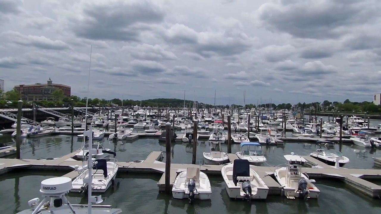 A marina filled with numerous small boats docked in slips under a cloudy sky.