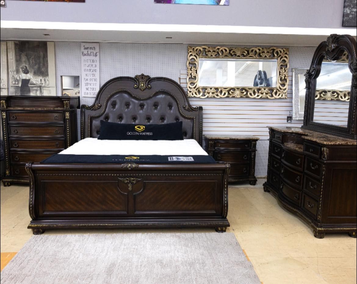 Bedroom set with dark wood bed, dresser, nightstand, and mirror in a showroom. Bayou furniture New Orleans