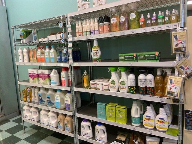 A store shelf filled with lots of cleaning products.
