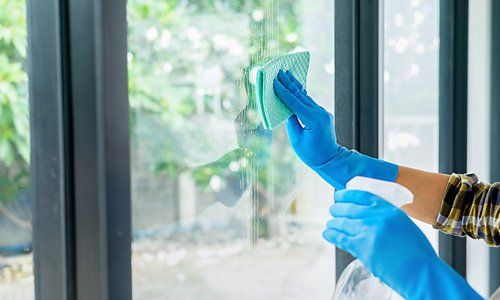 Window cleaning with a soft cloth and spray bottle