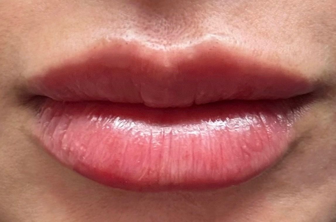 Close-up of closed pink lips and surrounding skin