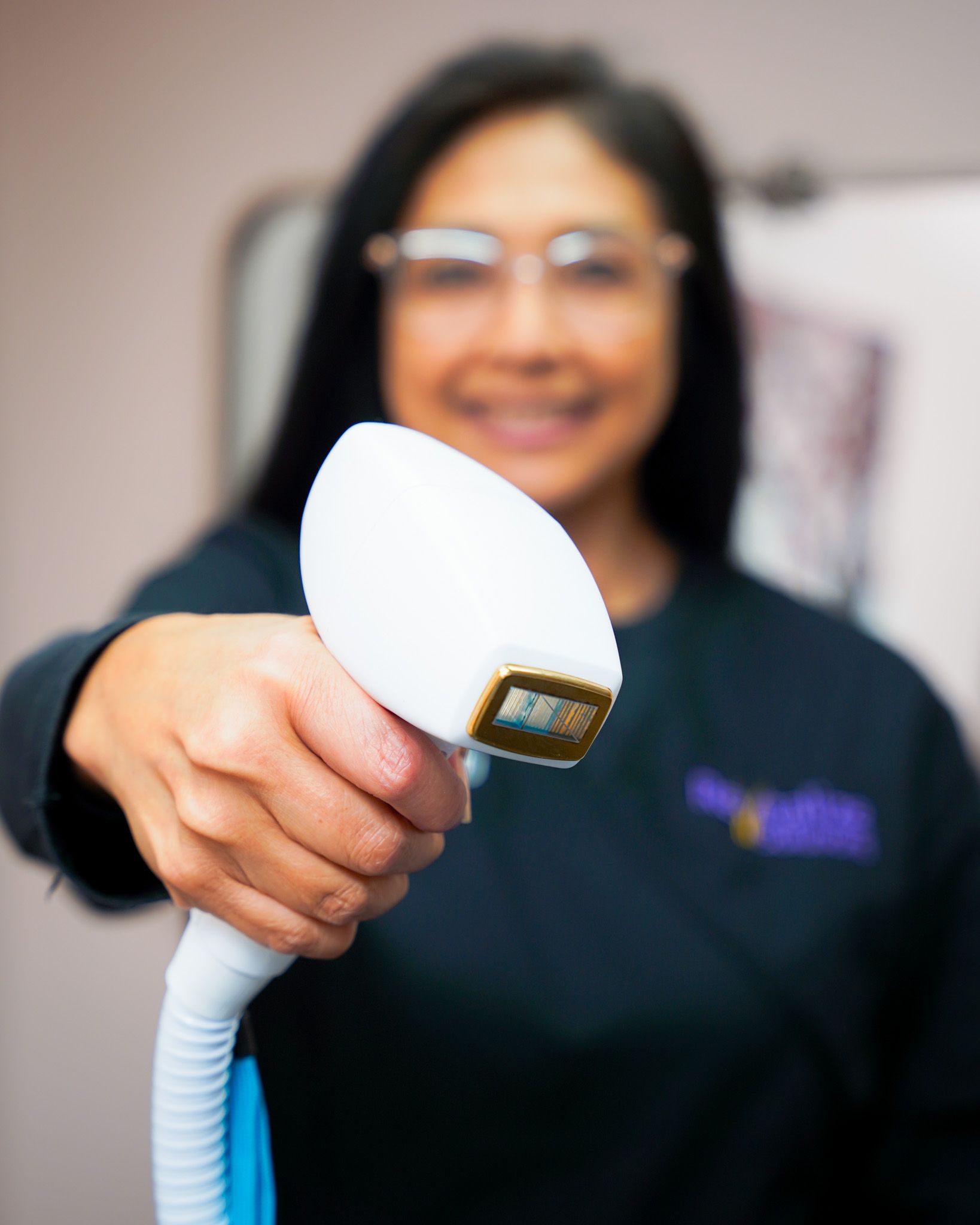 A woman is holding a white device in her hand.