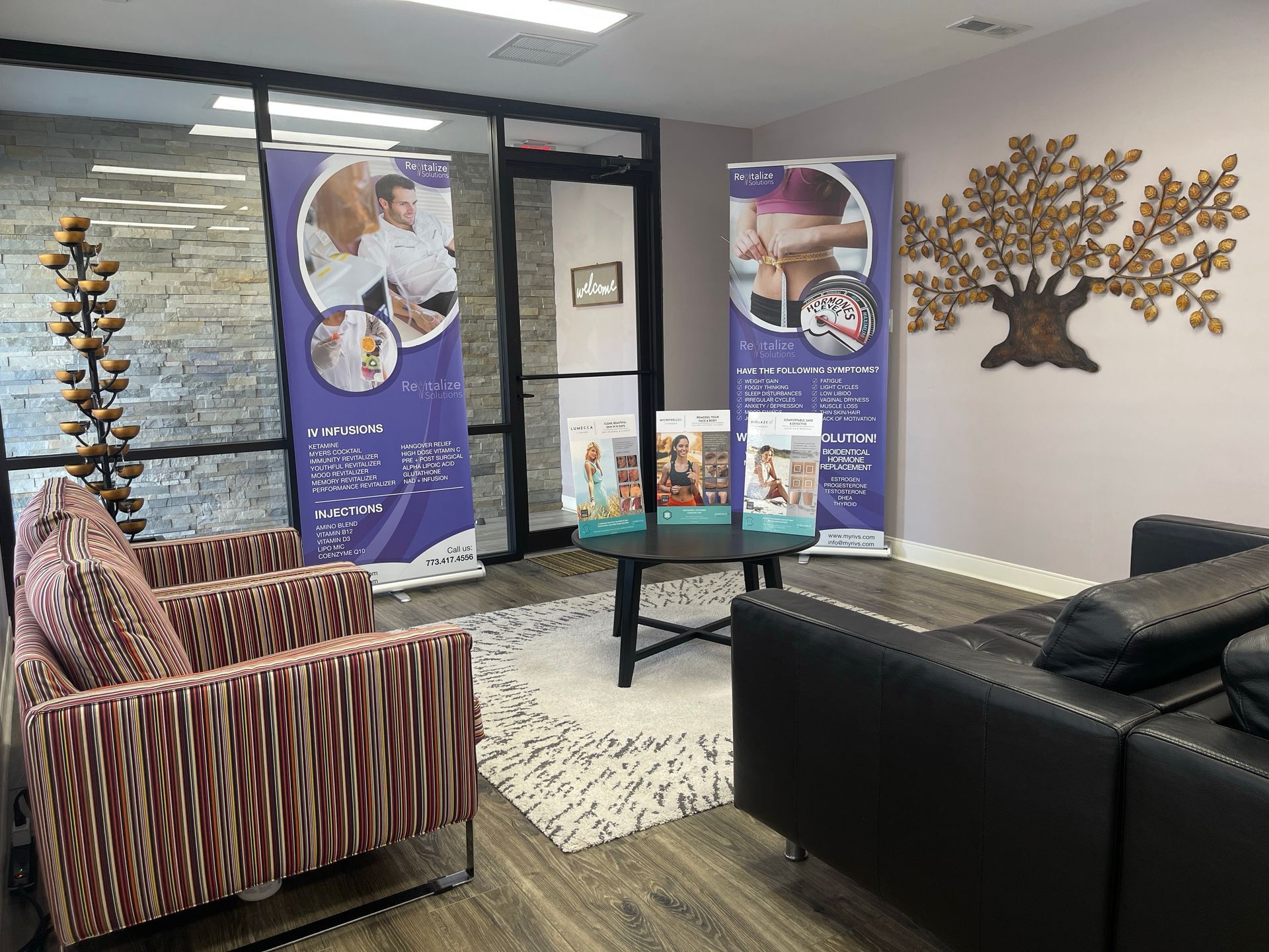 A living room with a couch , chairs , and a table.