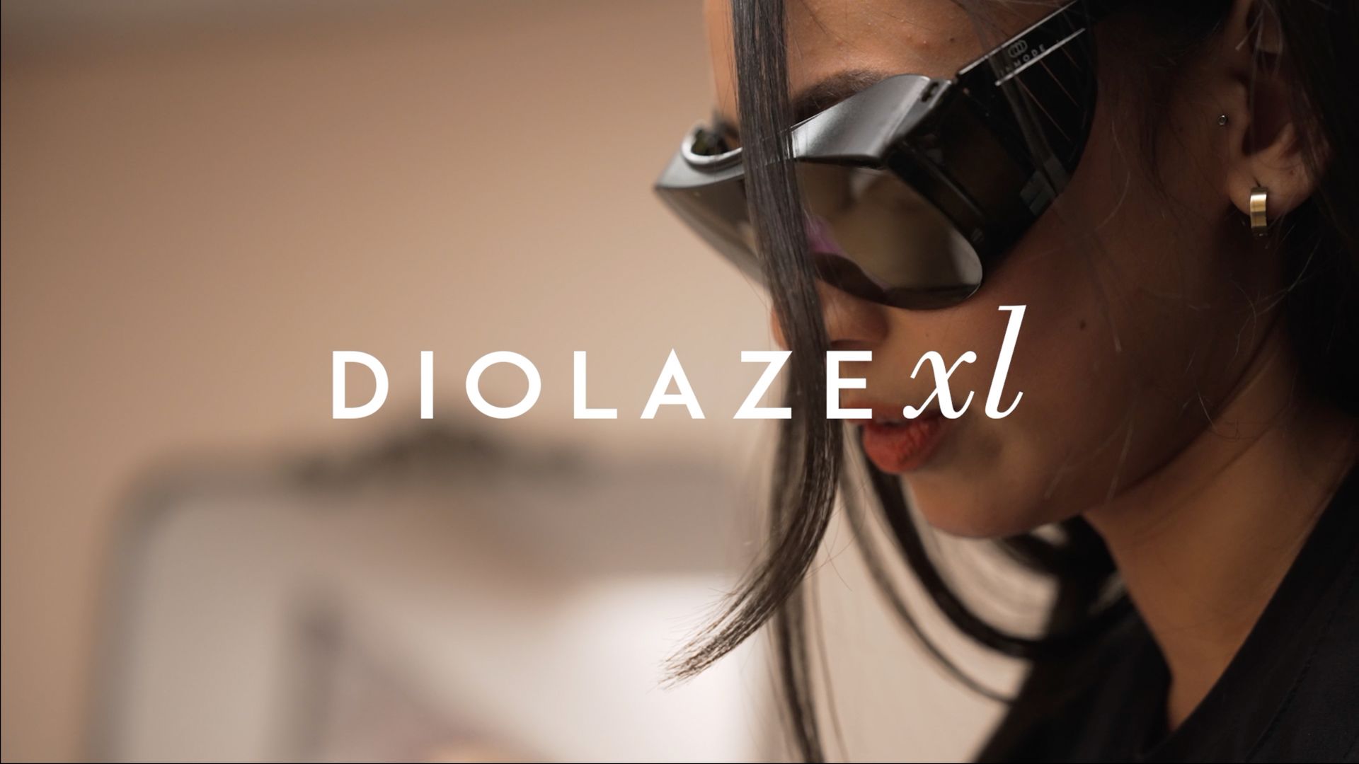 A woman wearing sunglasses with the word diolaze xl on the bottom