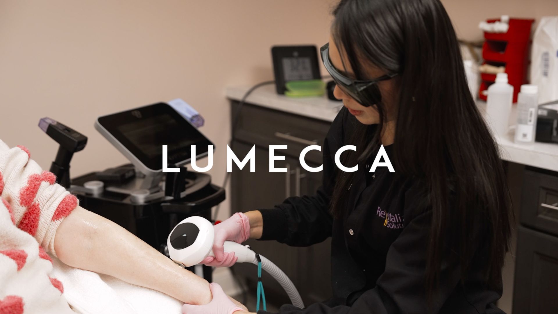 A woman is getting a laser hair removal treatment on her arm.