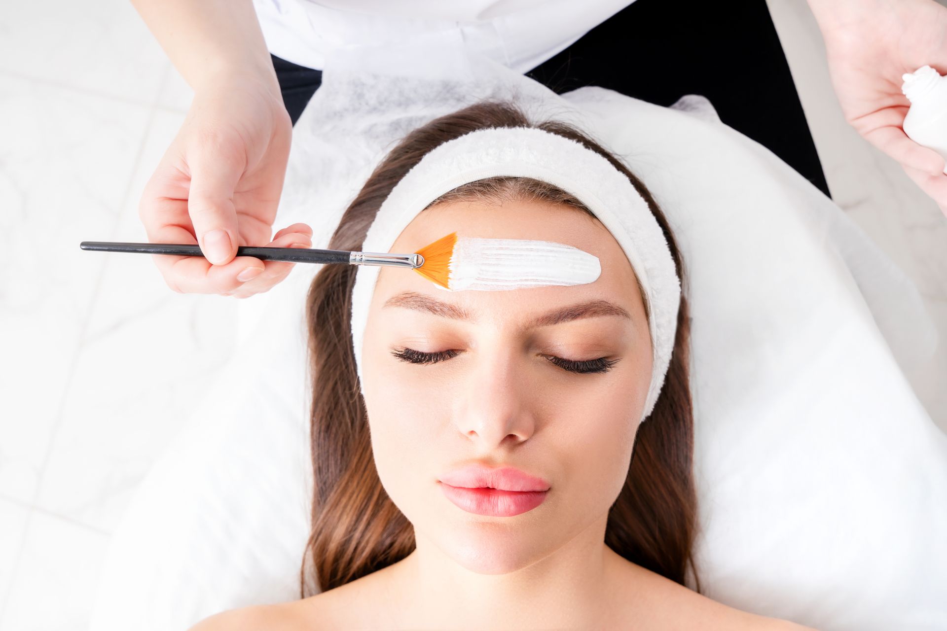 A woman is getting a facial treatment at a spa.