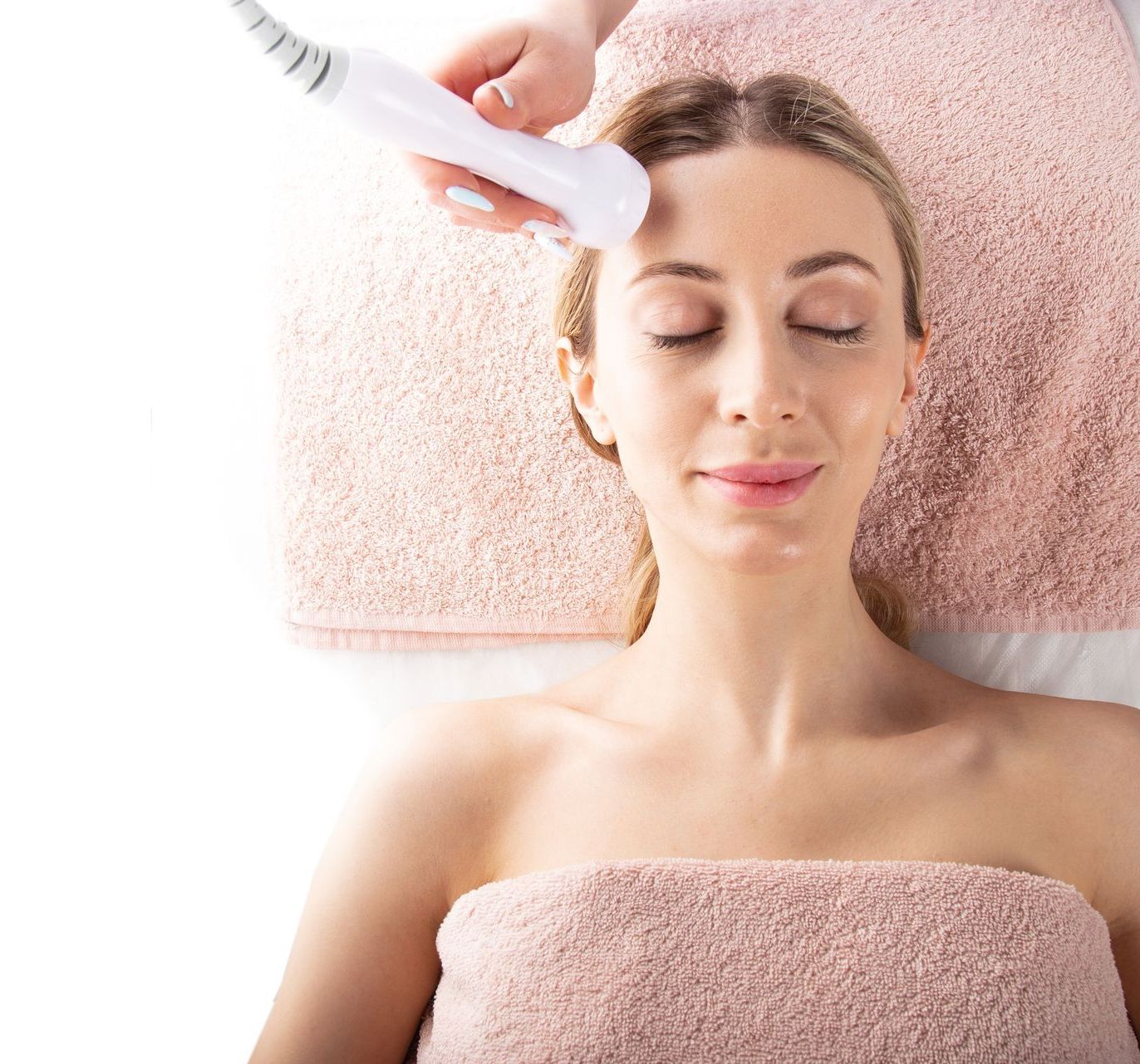 A woman is getting a facial treatment at a spa.