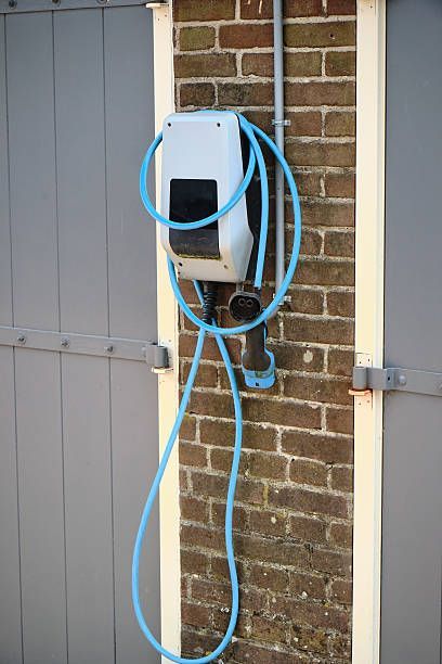 Air conditioning units with toolbox and gloves in backyard.